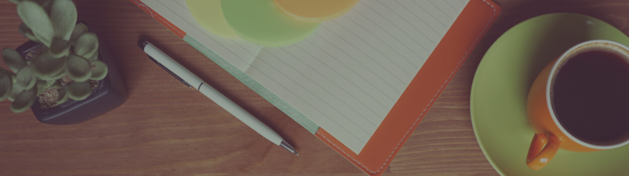 notebook on tabletop with pen